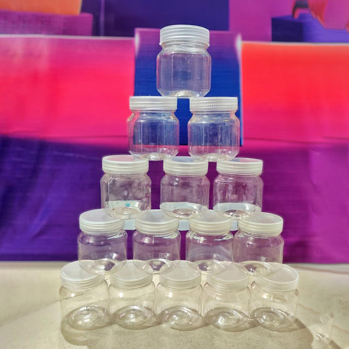 Picture of Store Small Items With This Set Of 100Ml Transparent Plastic Jars- Comes In A Multicolor Set Of 12 Pieces For Versatile Use