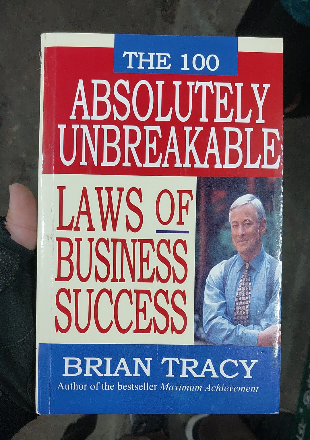 Picture of The 100 Absolutely Unbreakable Laws of Business Success by Brian Tracy (Yellowish - Paperback)