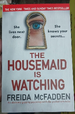 Picture of The Housemaid Is Watching Book by Freida McFadden - Yellow - Paperback