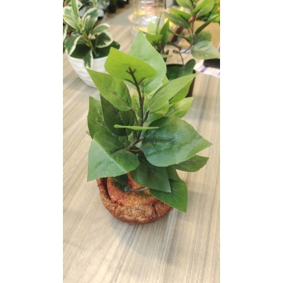 Picture of Artifacial Tree plants with The plant is a small, artificial bonsai-style plant with green leaves in a textured, terracotta-colored pot.