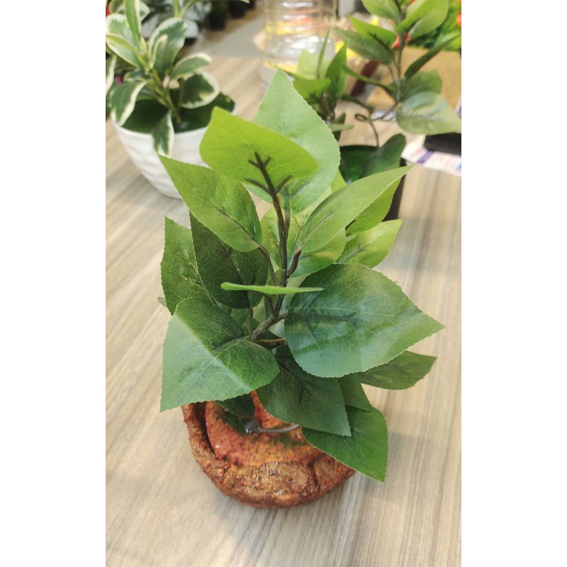 Picture of Artifacial Tree plants with The plant is a small, artificial bonsai-style plant with green leaves in a textured, terracotta-colored pot.