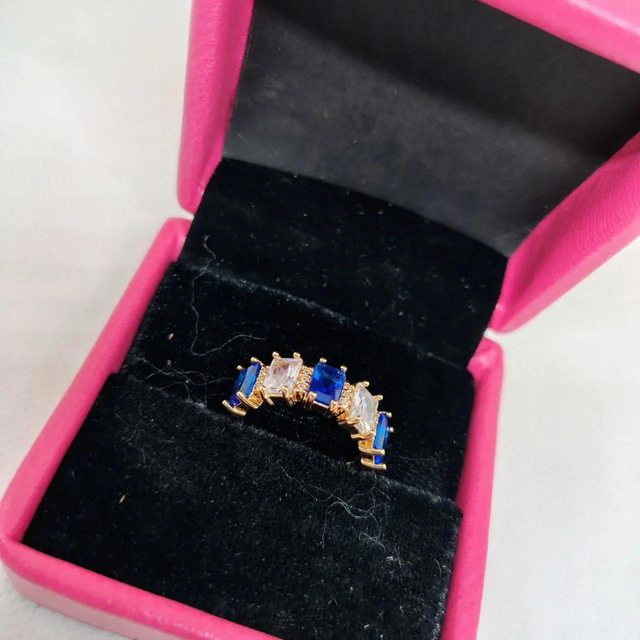 Picture of vibrant gold ring adorned with colorful gemstones,