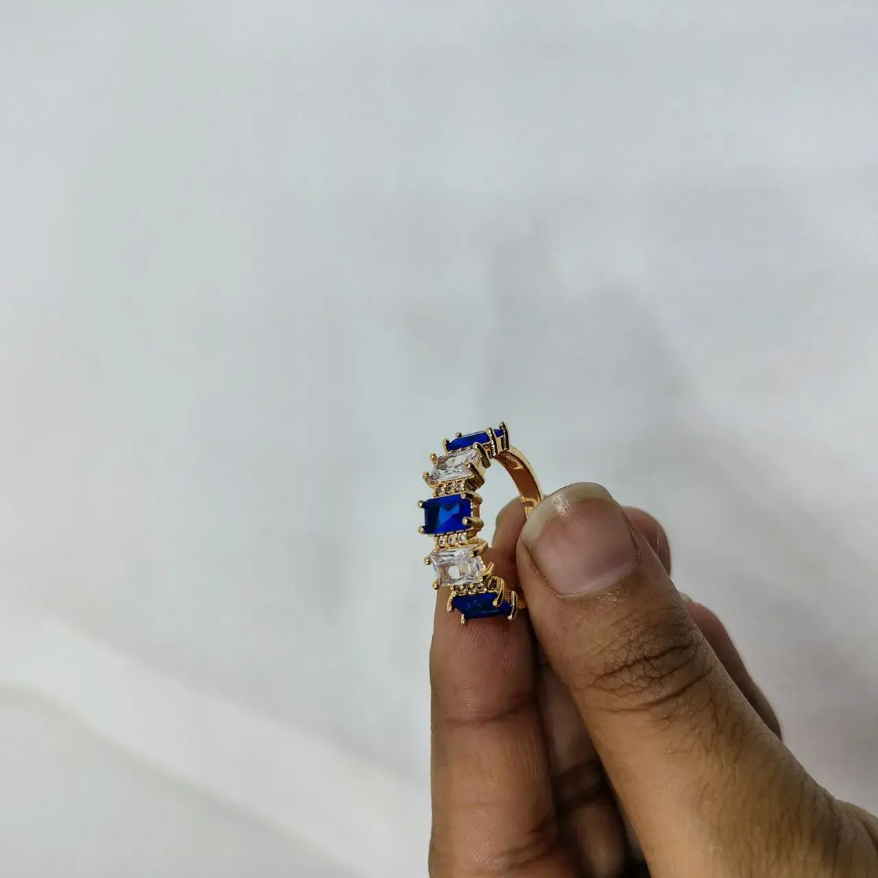 Picture of vibrant gold ring adorned with colorful gemstones,