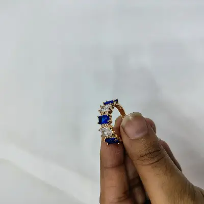 Picture of vibrant gold ring adorned with colorful gemstones,