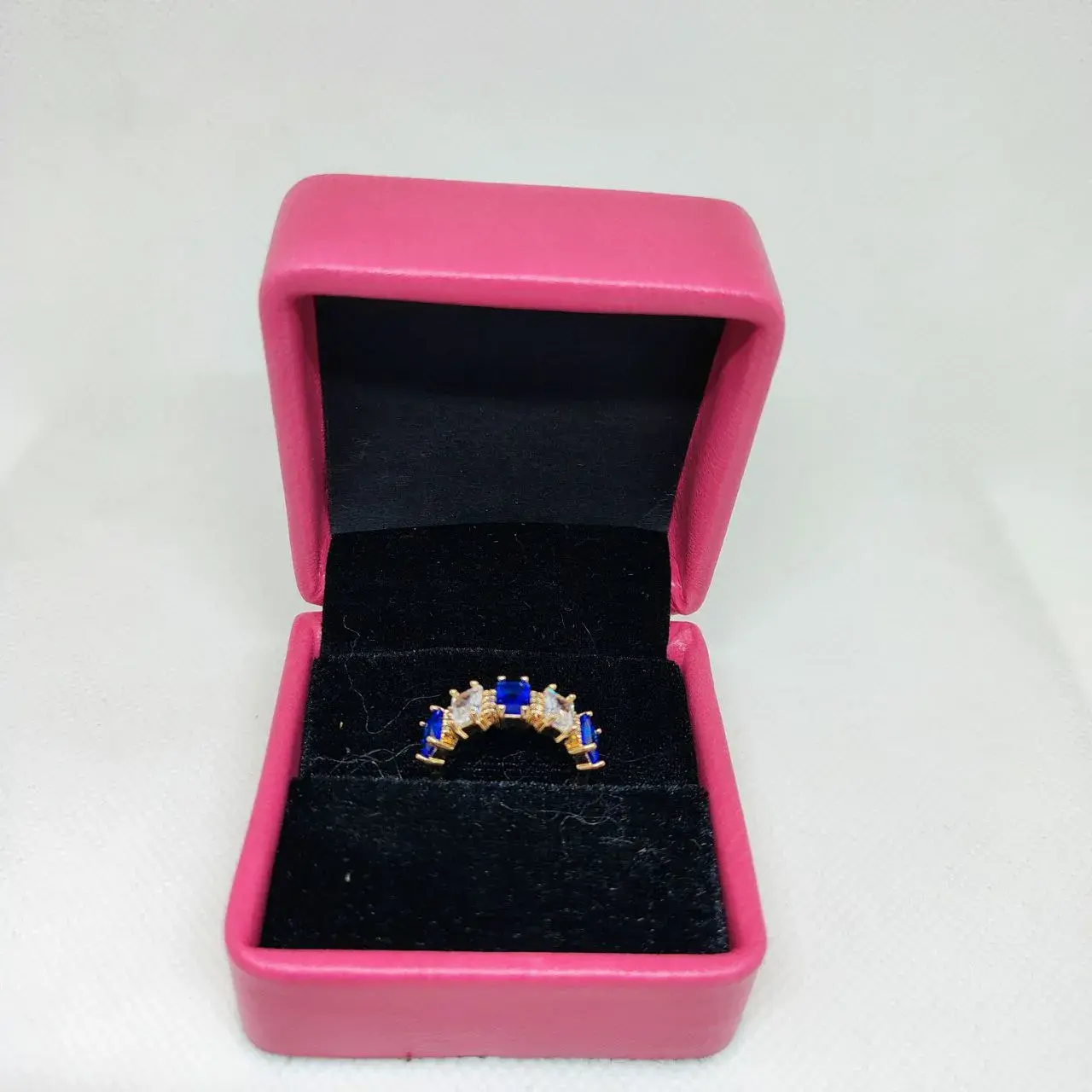 Picture of vibrant gold ring adorned with colorful gemstones,