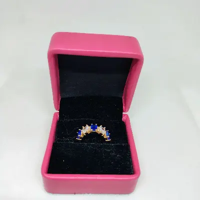Picture of vibrant gold ring adorned with colorful gemstones,