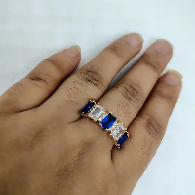 Picture of vibrant gold ring adorned with colorful gemstones,