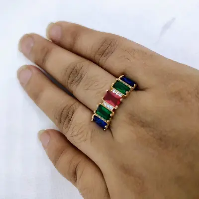 Picture of vibrant gold ring adorned with colorful gemstones,