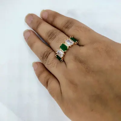 Picture of vibrant gold ring adorned with colorful gemstones,