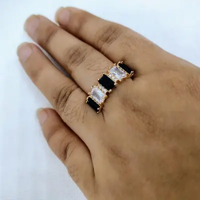 Picture of vibrant gold ring adorned with colorful gemstones.