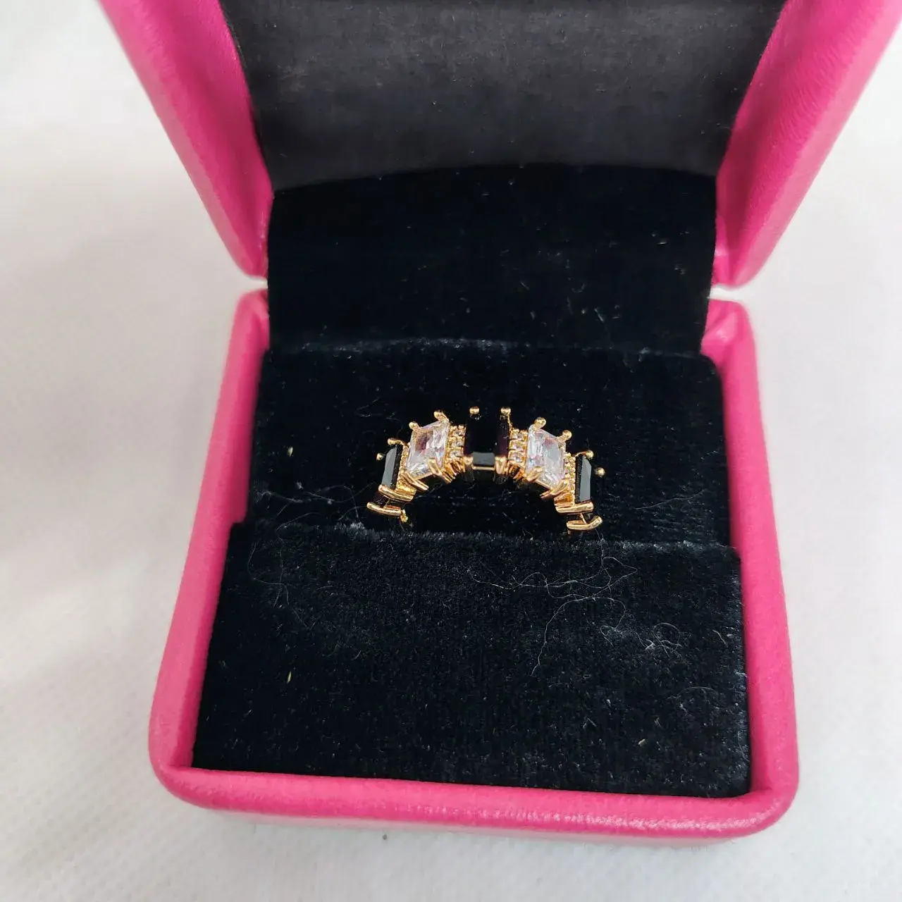 Picture of vibrant gold ring adorned with colorful gemstones.