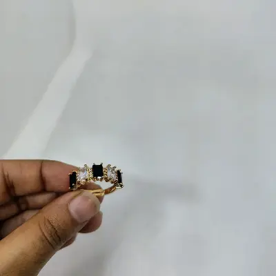 Picture of vibrant gold ring adorned with colorful gemstones.