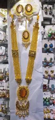 Picture of Elegant gold-plated jewelry set for women. Includes long necklace, earrings, and tikli. Perfect for wedding, party, and traditional wear. High-quality finish and stylish design.