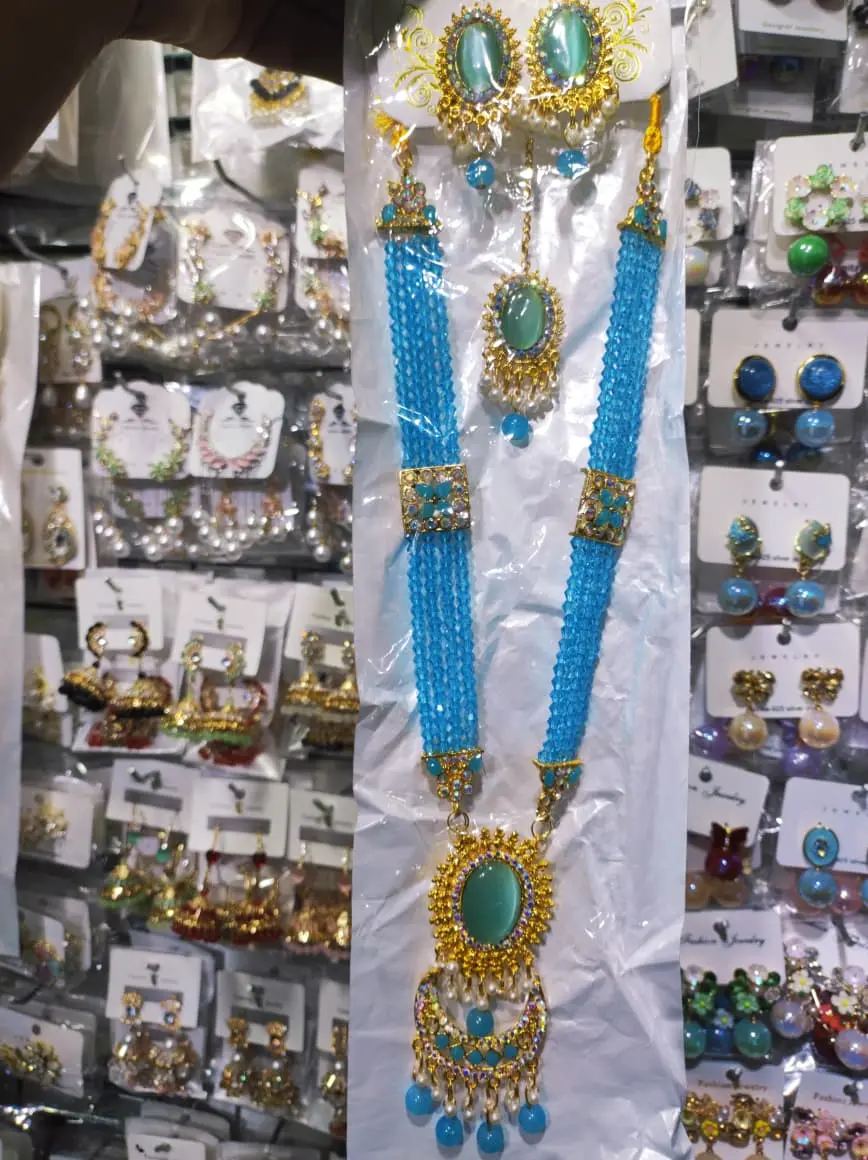 Picture of Elegant gold-plated jewelry set for women. Includes long necklace, earrings, and tikli. Perfect for wedding, party, and traditional wear. High-quality finish and stylish design.