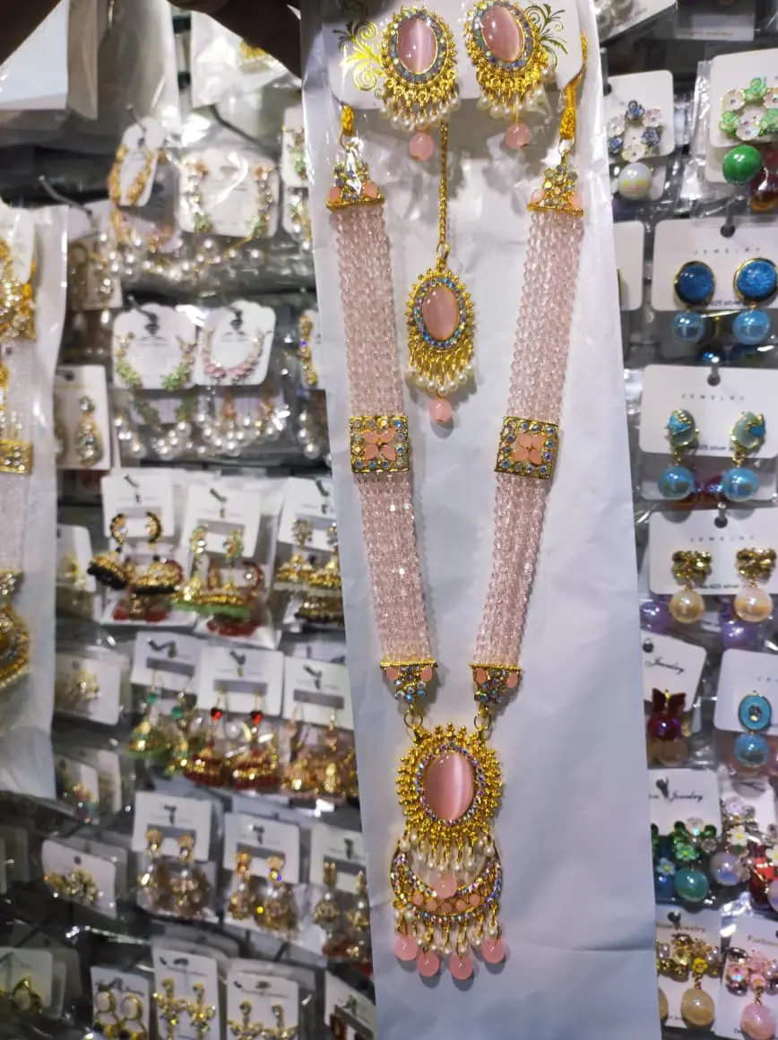 Picture of Elegant gold-plated jewelry set for women. Includes long necklace, earrings, and tikli. Perfect for wedding, party, and traditional wear. High-quality finish and stylish design.