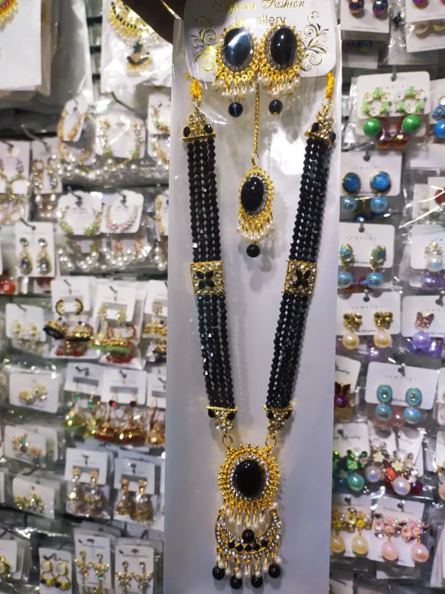 Picture of Elegant gold-plated jewelry set for women. Includes long necklace, earrings, and tikli. Perfect for wedding, party, and traditional wear. High-quality finish and stylish design.