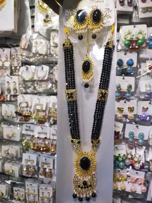 Picture of Elegant gold-plated jewelry set for women. Includes long necklace, earrings, and tikli. Perfect for wedding, party, and traditional wear. High-quality finish and stylish design.