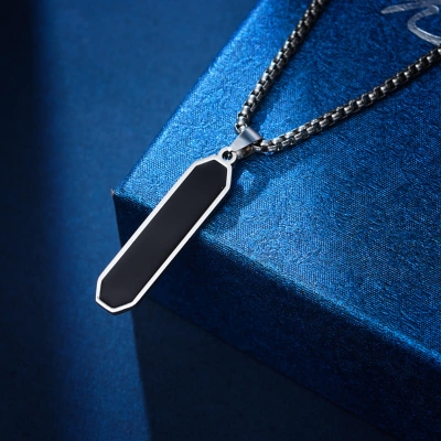 Picture of Pendant necklace on a stainless steel chain with a single titanium steel slanted rhombus pendant. Black 